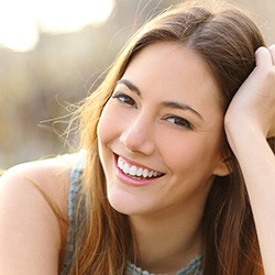 Close-up of woman sitting outside and smiling