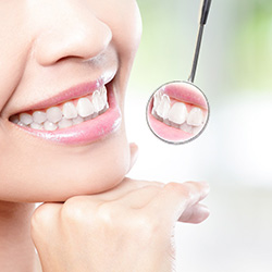 Woman showing off smile in a dental mirror