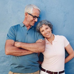 Older couple standing in front of blue wall