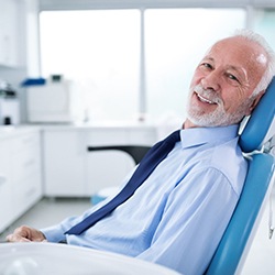 Man in tie sitting in a dental chair