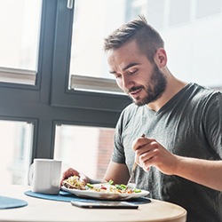 Man sitting at table eating healthy meal