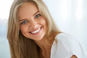 woman blonde hair smiling perfect teeth